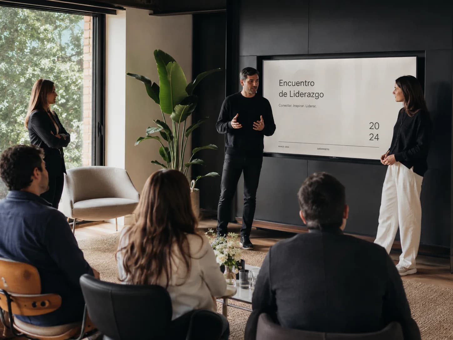 Presentation in front of a screen at a company leadership meeting
